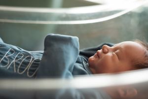 Artistic overhead view of baby sleeping with soft natural light.