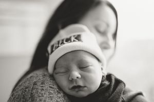 Black and white portrait of a peaceful sleeping newborn baby.