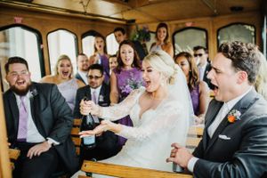 Joyful celebration moment on a vintage trolley during wedding festivities.
