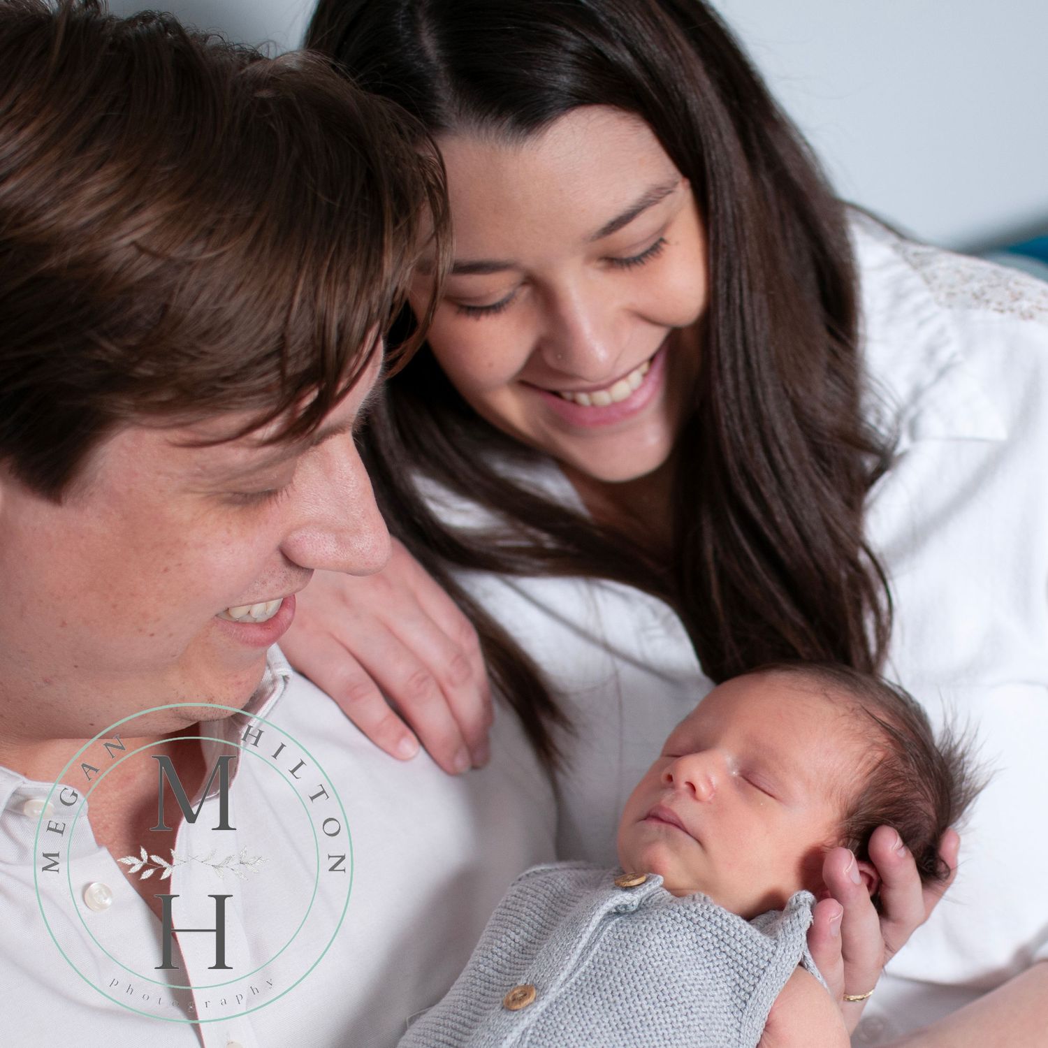 Close up candid photo of family with newborn