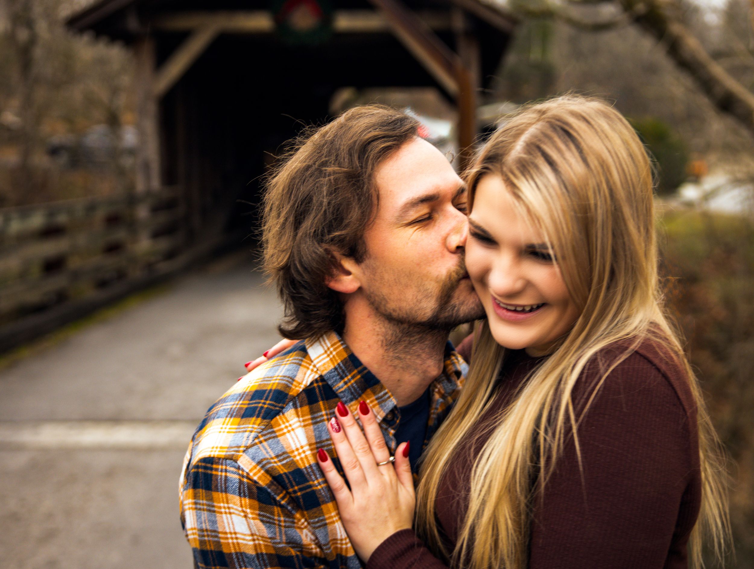 A romantic couple shares intimate moments outdoors in a series of candid photographs.