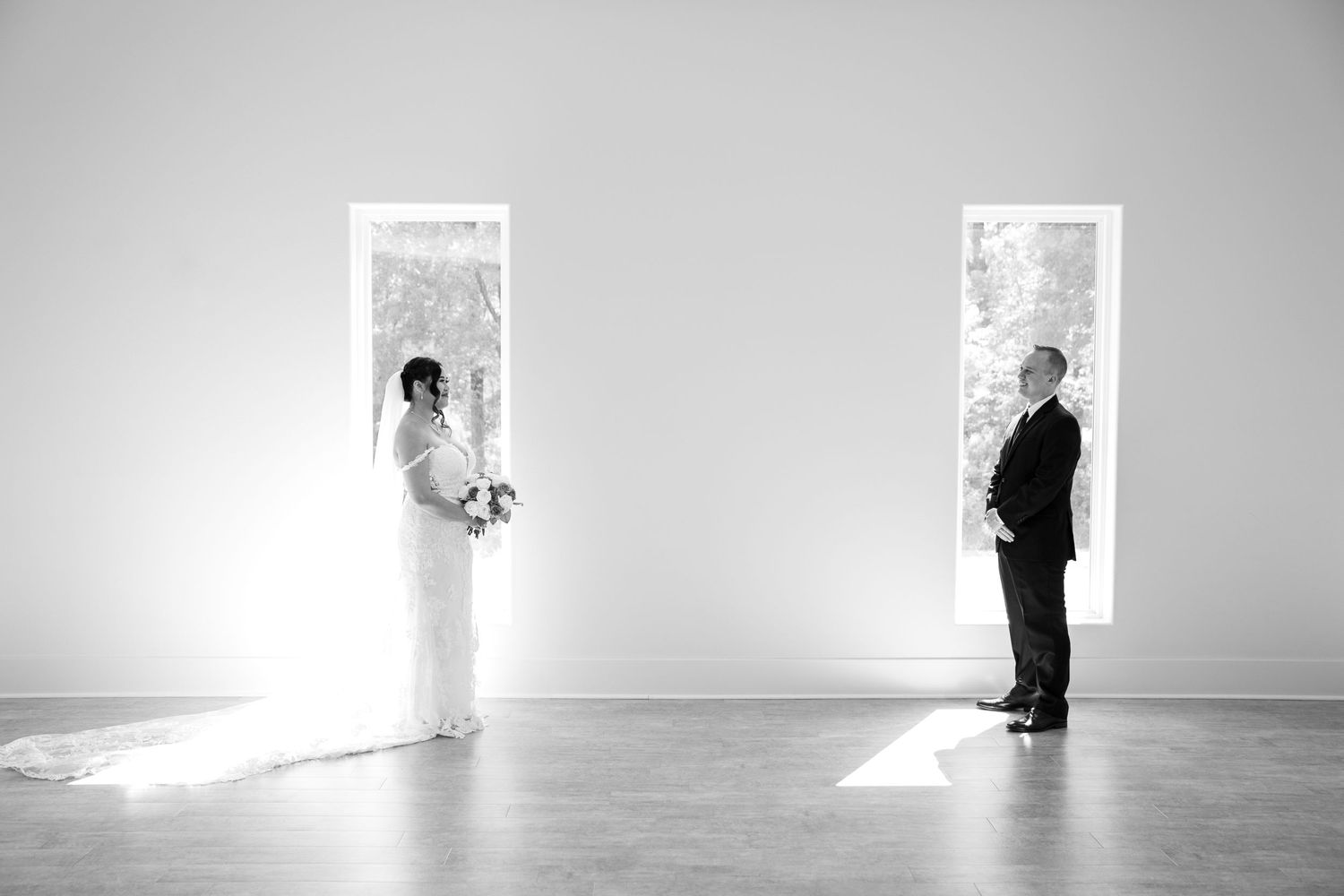 Minimalist black and white wedding photos in a bright, modern interior space.