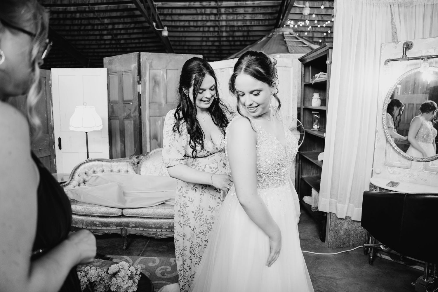 Wedding preparation moments captured in black and white as wedding dress details and getting ready activities unfold.