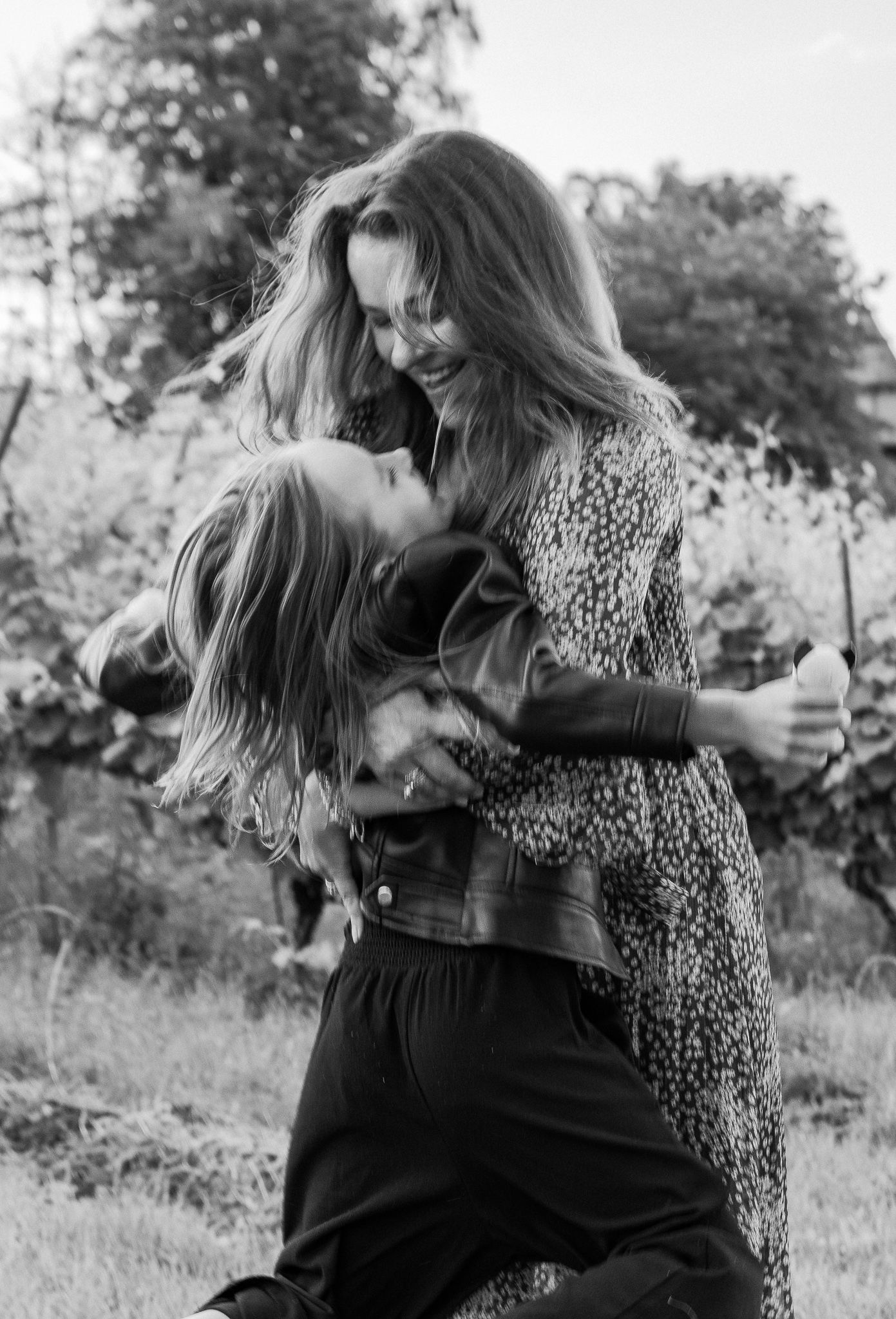A woman hugs her daugher.