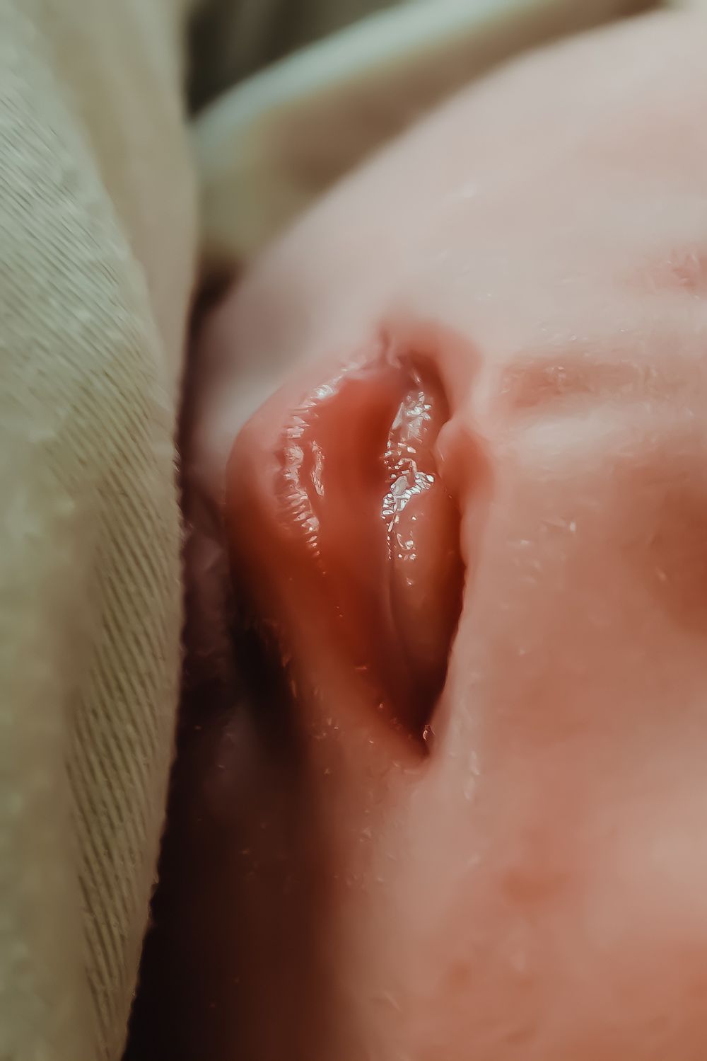 Extreme close-up of a newborn baby's pink lips and mouth.