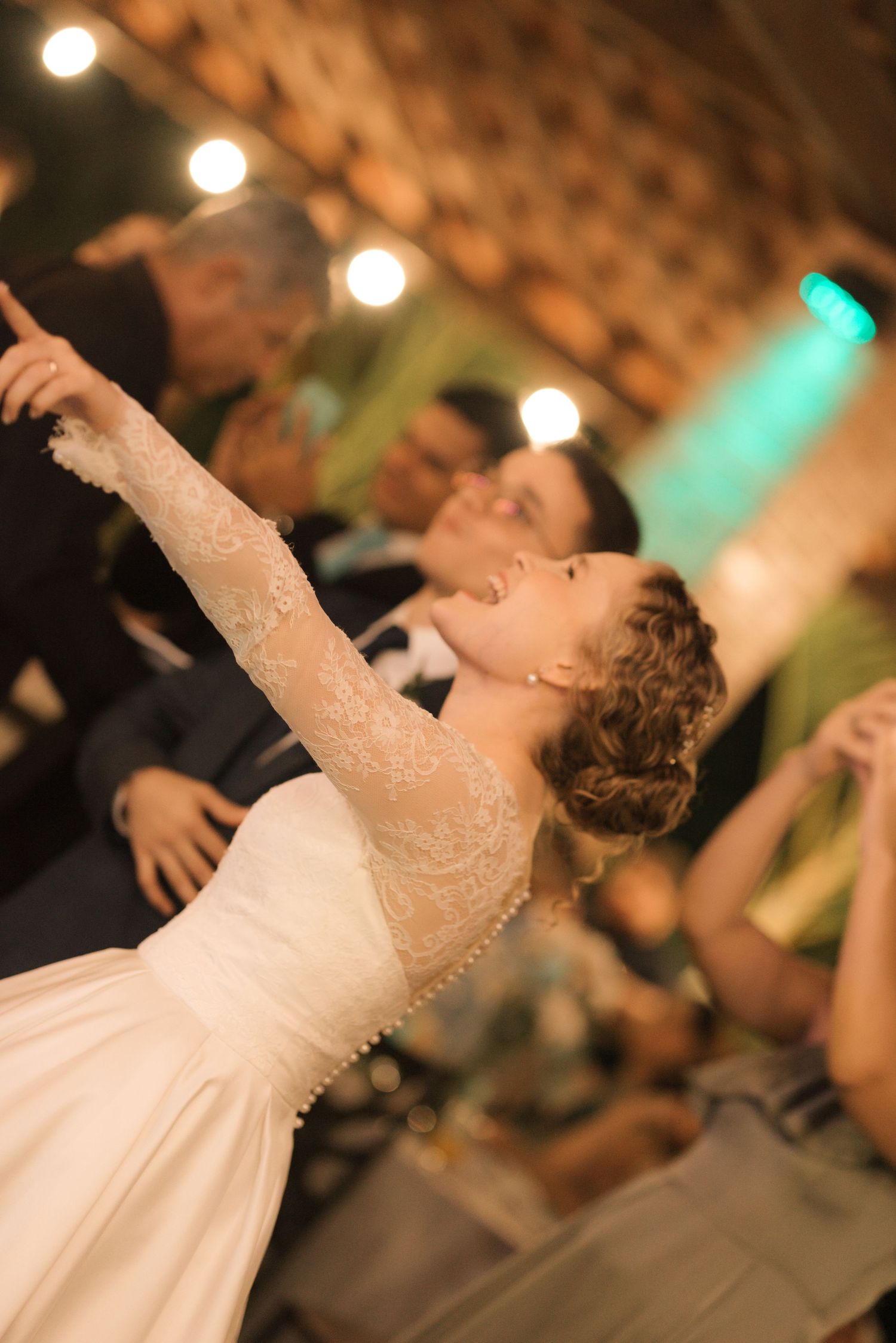 A graceful dance move captured during a wedding reception with ambient lighting.