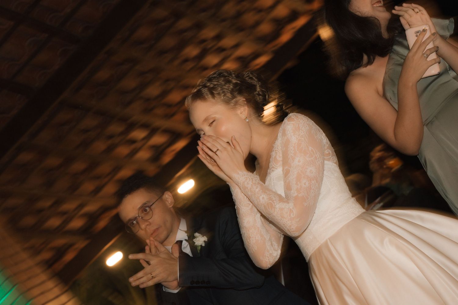 A candid reaction of delight and surprise during wedding festivities.