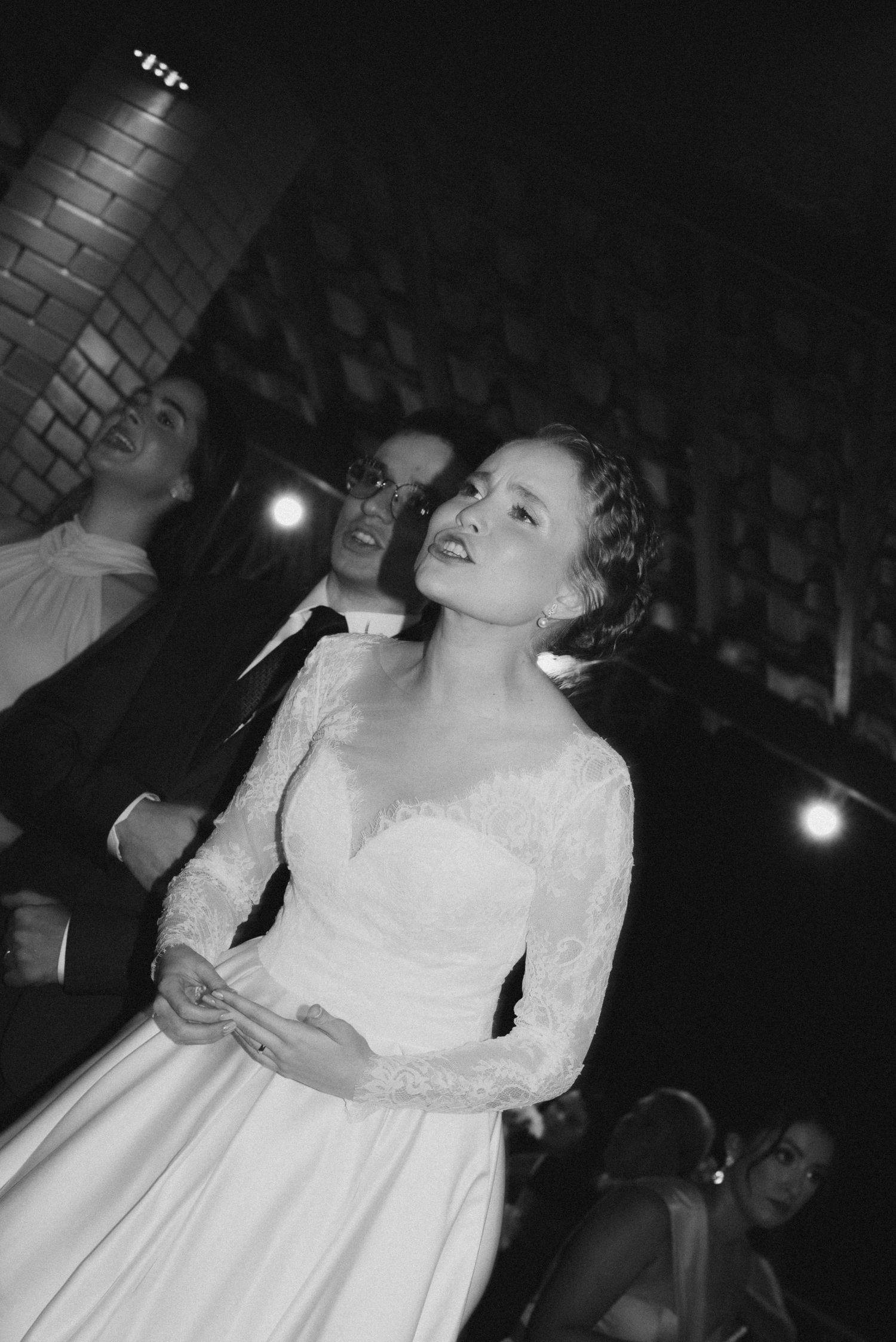 A black and white capture of an elegant wedding celebration moment.