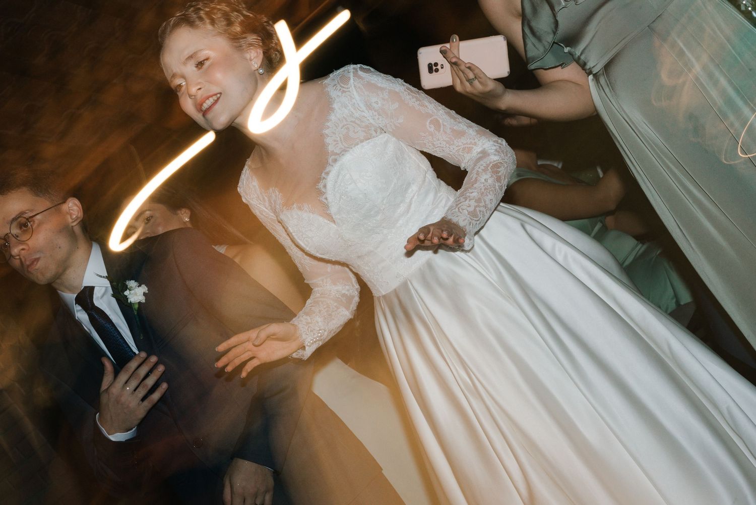 A dynamic wedding reception shot with light trails and motion blur effects.