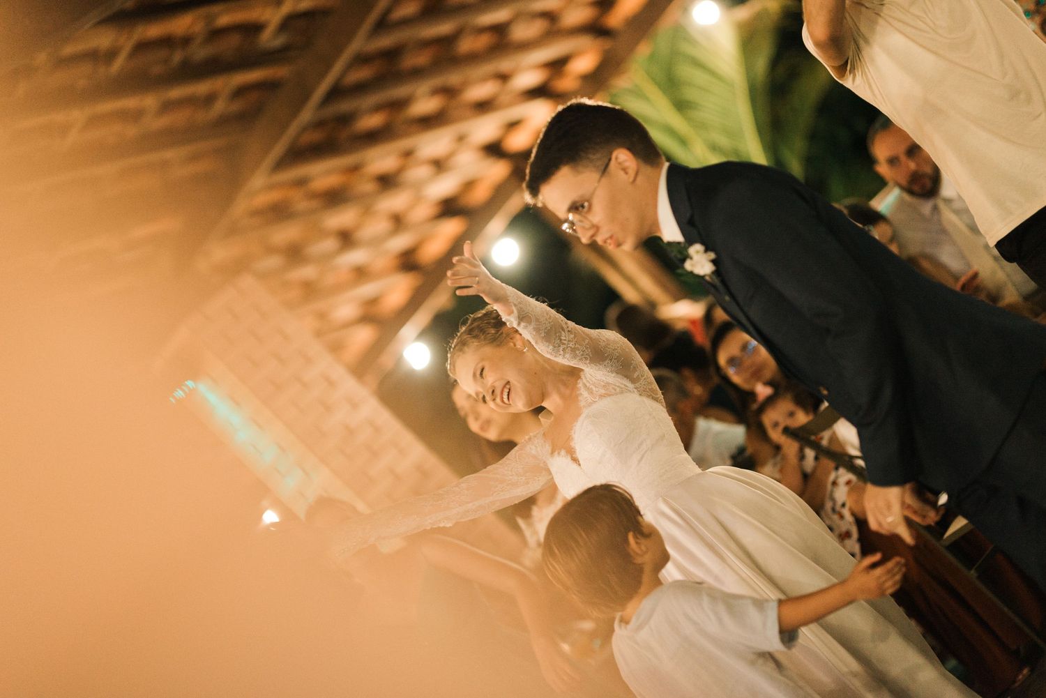 Dancing couple celebrating at their wedding reception with ambient lighting.
