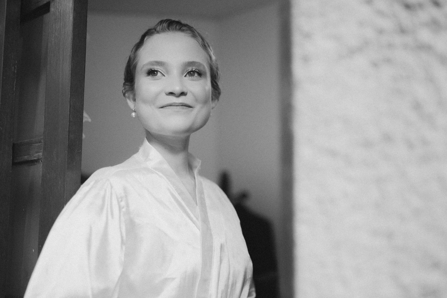 Classic black and white portrait with upward gaze and gentle smile.