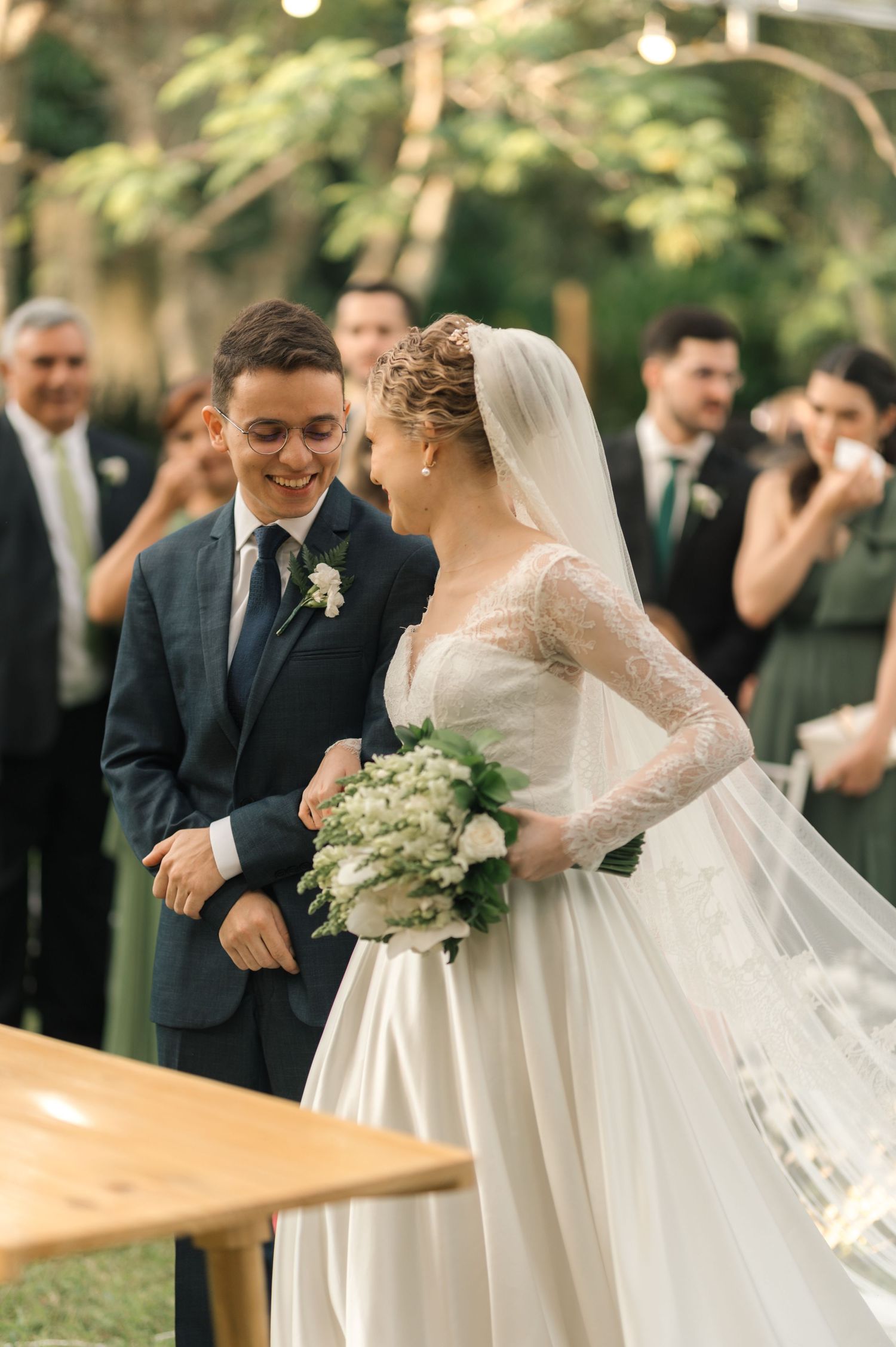Candid moment between newlyweds during outdoor garden wedding ceremony.