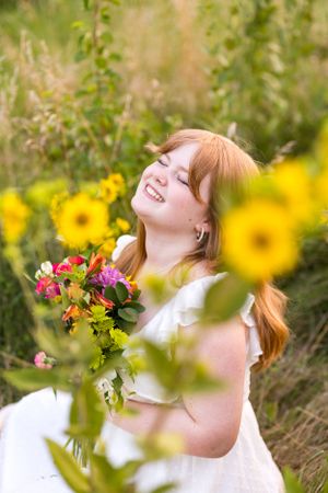 Female High School Senior in a field with flowers