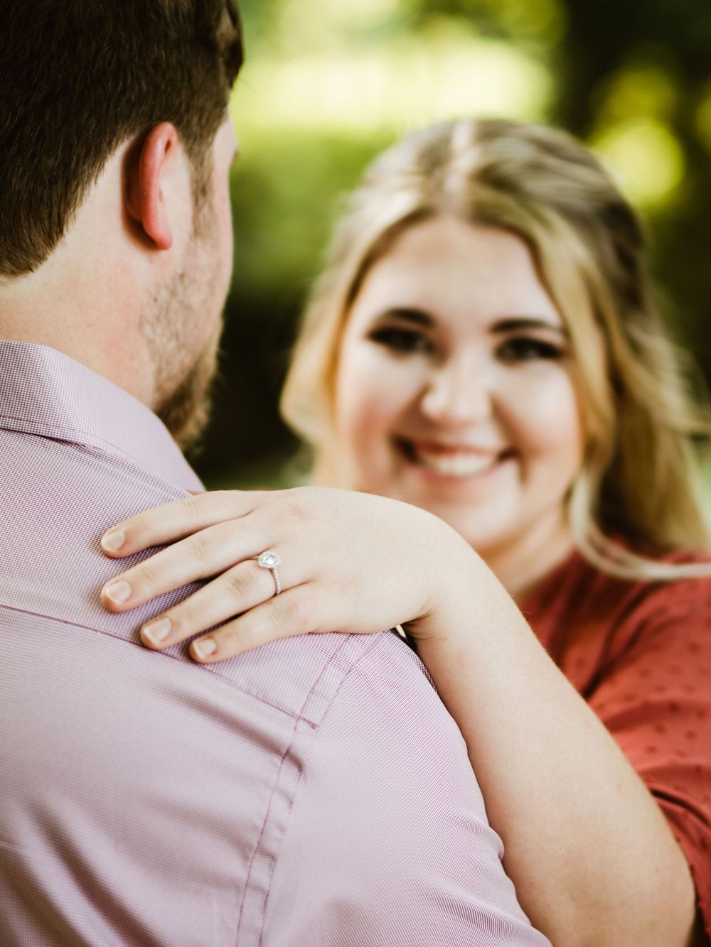 A close-up shot shows a couple sharing a tender moment with an engagement ring visible.