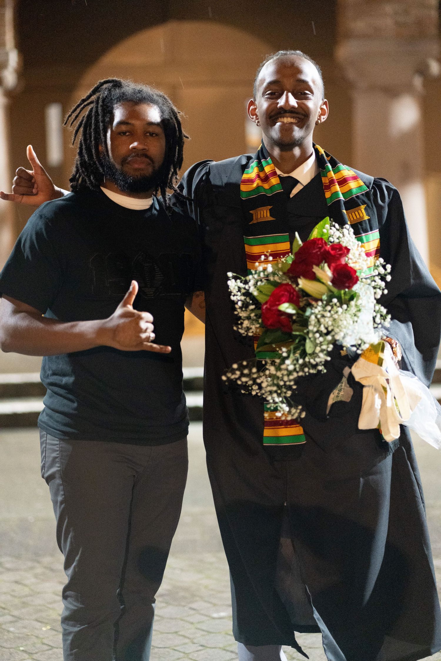 A series of connected photos showing two people in black clothing exchanging flowers and dancing together.
