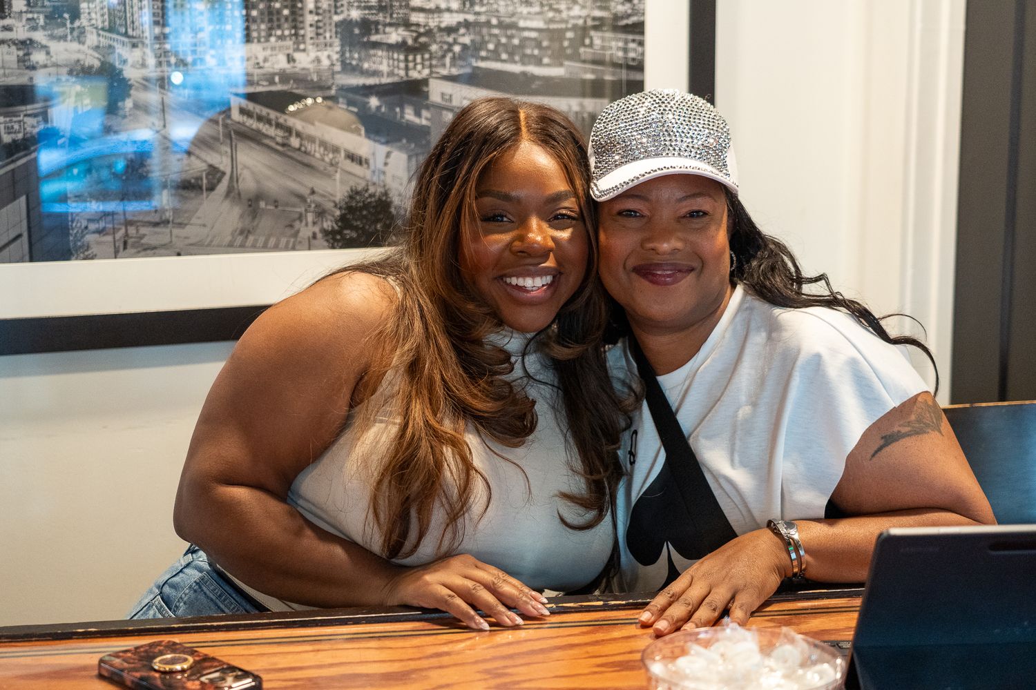 Two people share a joyful moment while sitting together at a table.