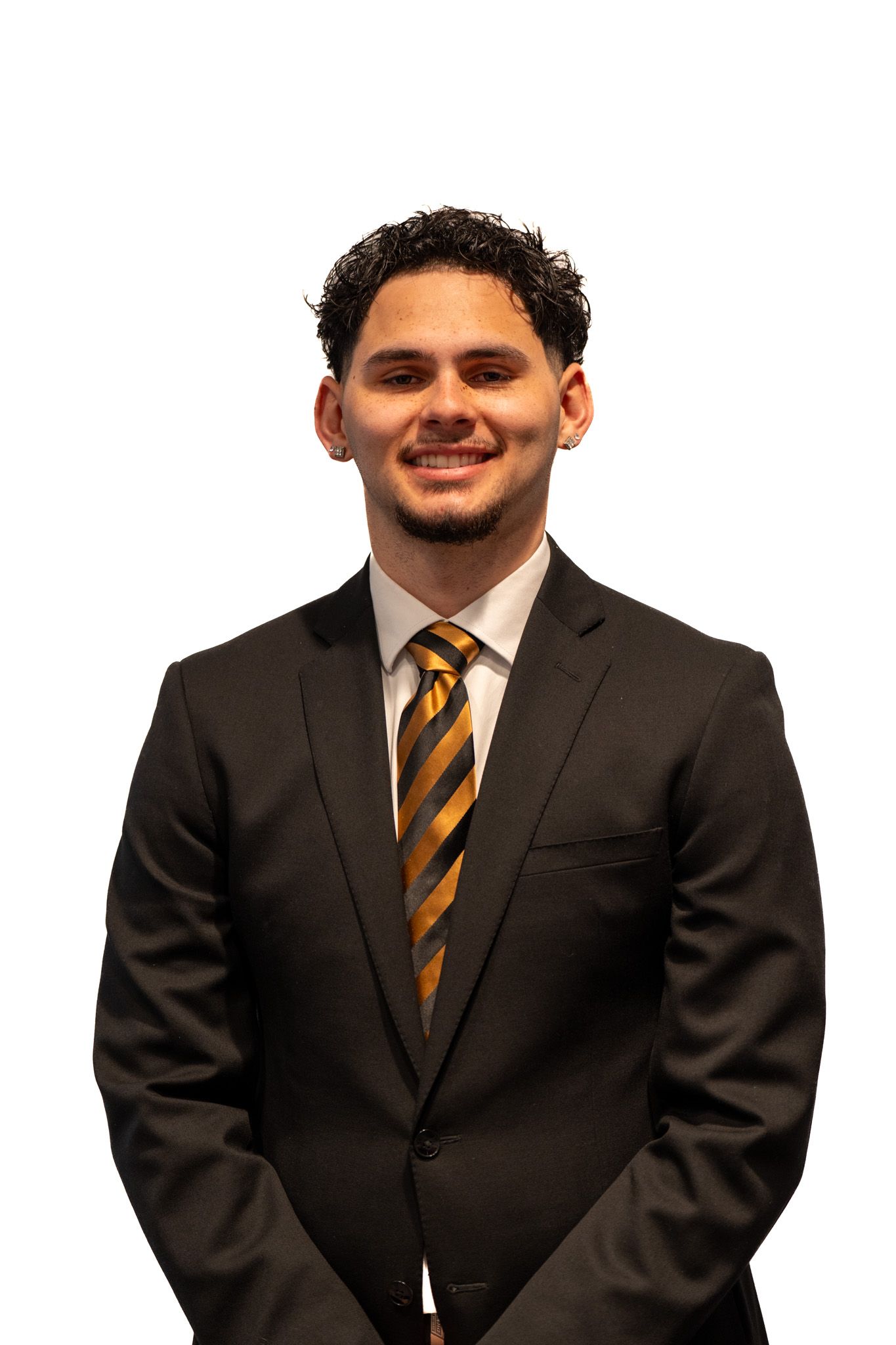 Professional headshot of person wearing dark suit with striped orange and black tie against white background.