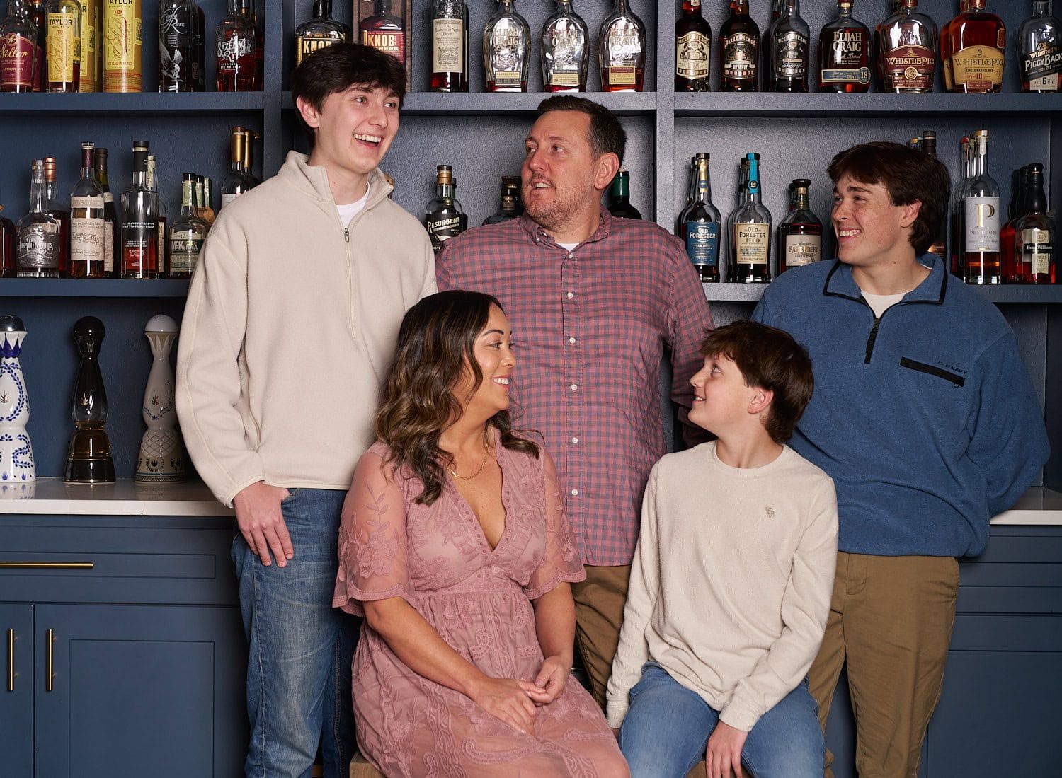 Family of five with three teenage boys in a bourbon room