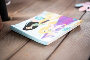 An artisticcolorful napkin designs lies on a wooden surface at a birthday party.