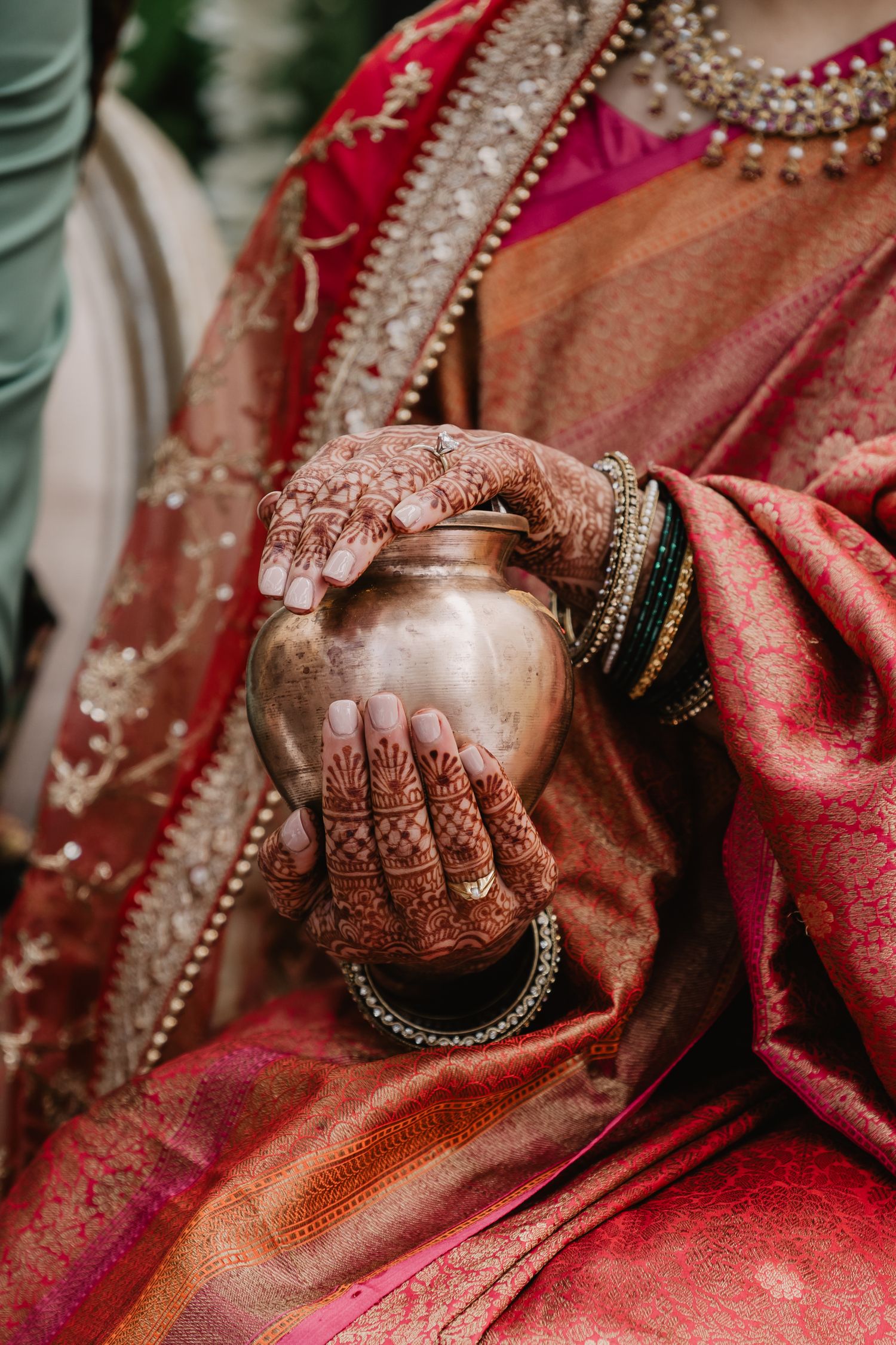 A white wedding dress photographed against a scenic balcony overlooking a waterfront.