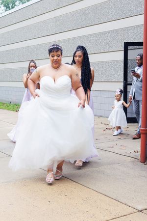 A wedding portrait of a bride walking to her first look photographed by Hudson Valley based photographer, Sasha Pierre-Louis
