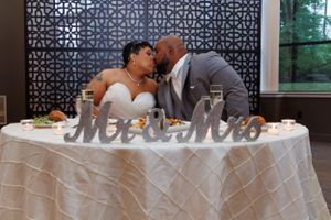 A couple at their sweetheart table photographed by Hudson Valley based photographer, Sasha Pierre-Louis