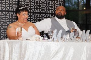 A couple at their sweetheart table photographed by Hudson Valley based photographer, Sasha Pierre-Louis