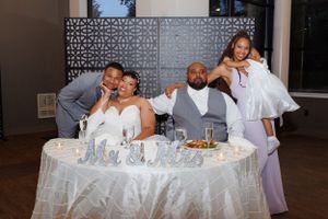 A couple at their sweetheart table photographed by Hudson Valley based photographer, Sasha Pierre-Louis