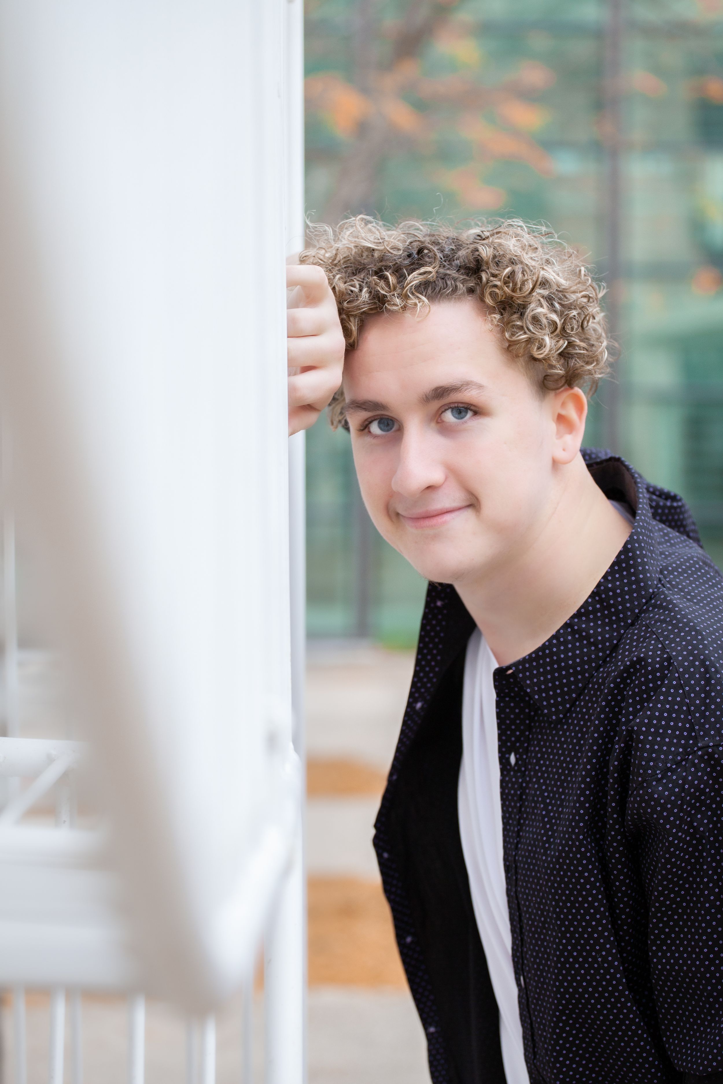 Artistic portrait by a window with soft natural lighting.