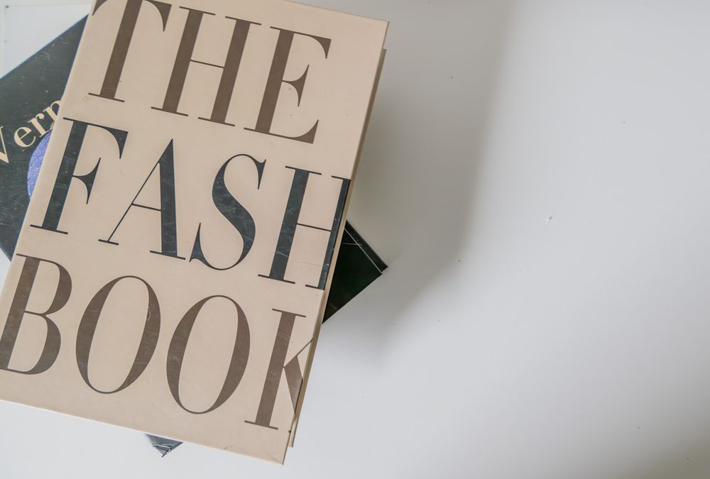 A minimalist beige book cover titled 'THE FASH BOOK' against a neutral background.
