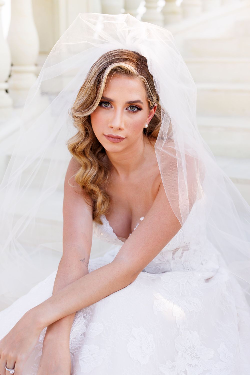 Ethereal bridal portrait with flowing veil and romantic soft lighting.