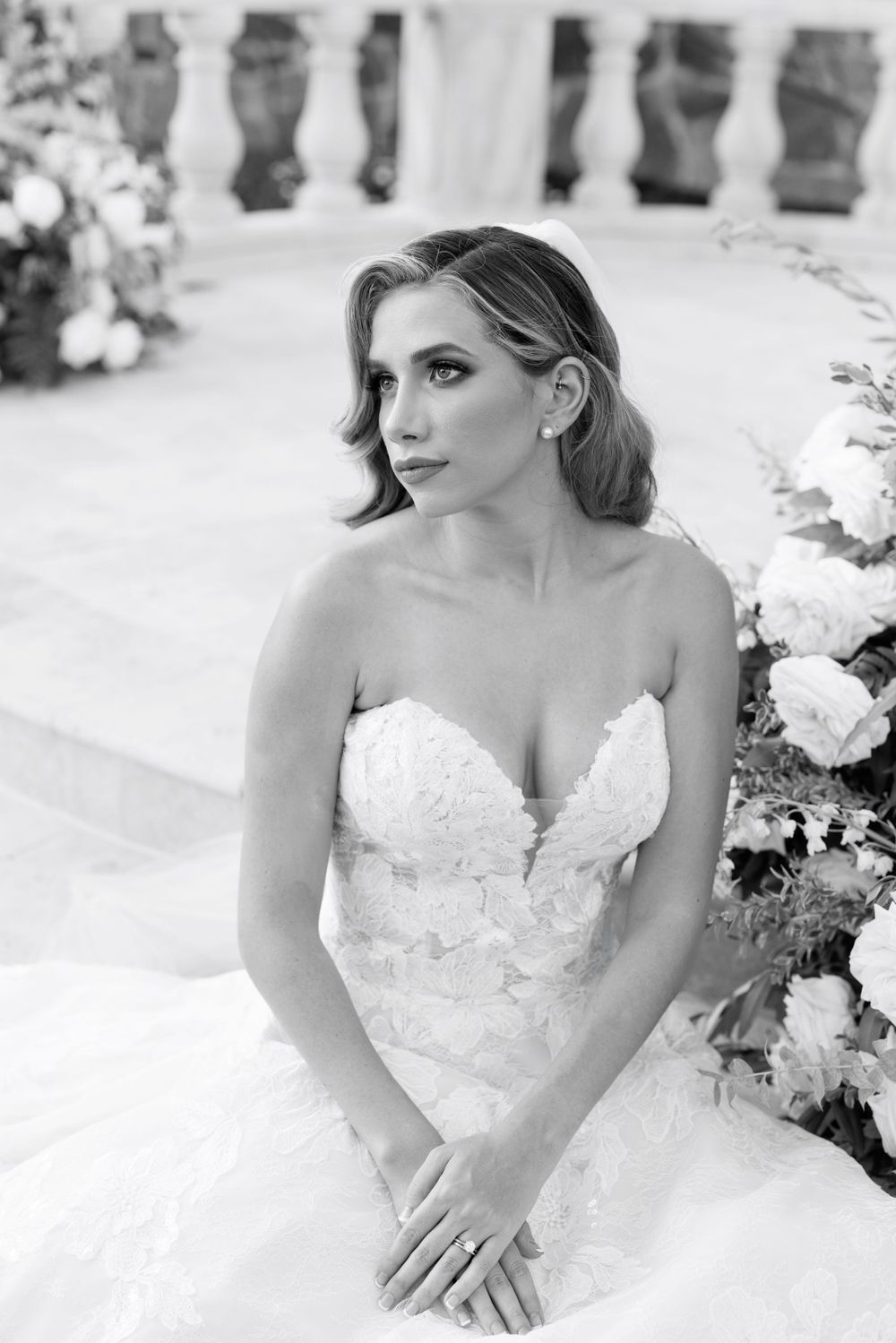 Black and white bridal portraits showcasing intricate lace details of a strapless wedding dress.
