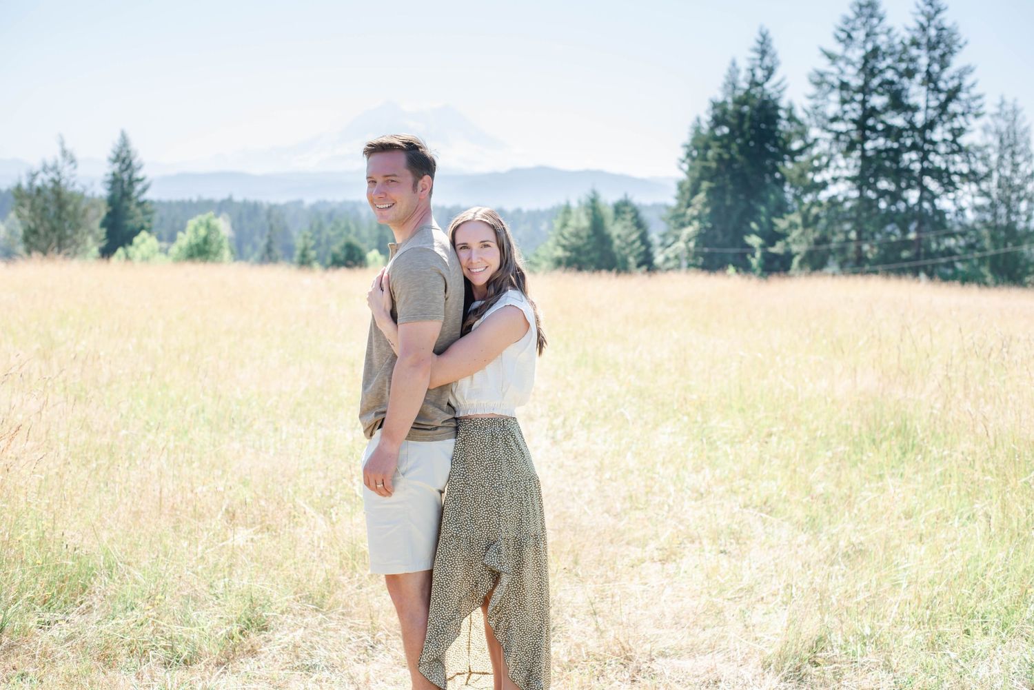 Romantic couples photoshoot in a sun-drenched mountain meadow.