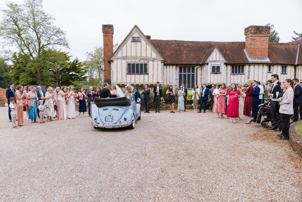 Bride and groom arriving to the reception at Harper Weddings Cain Manor in Hampshire.
