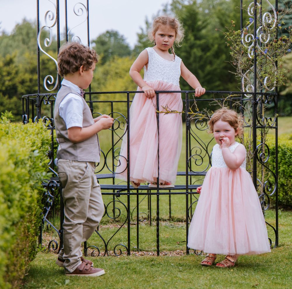 Children playing in gardens of Cain Manor Harper Weddings in Hampshire, captured by Sylvia Patchell.