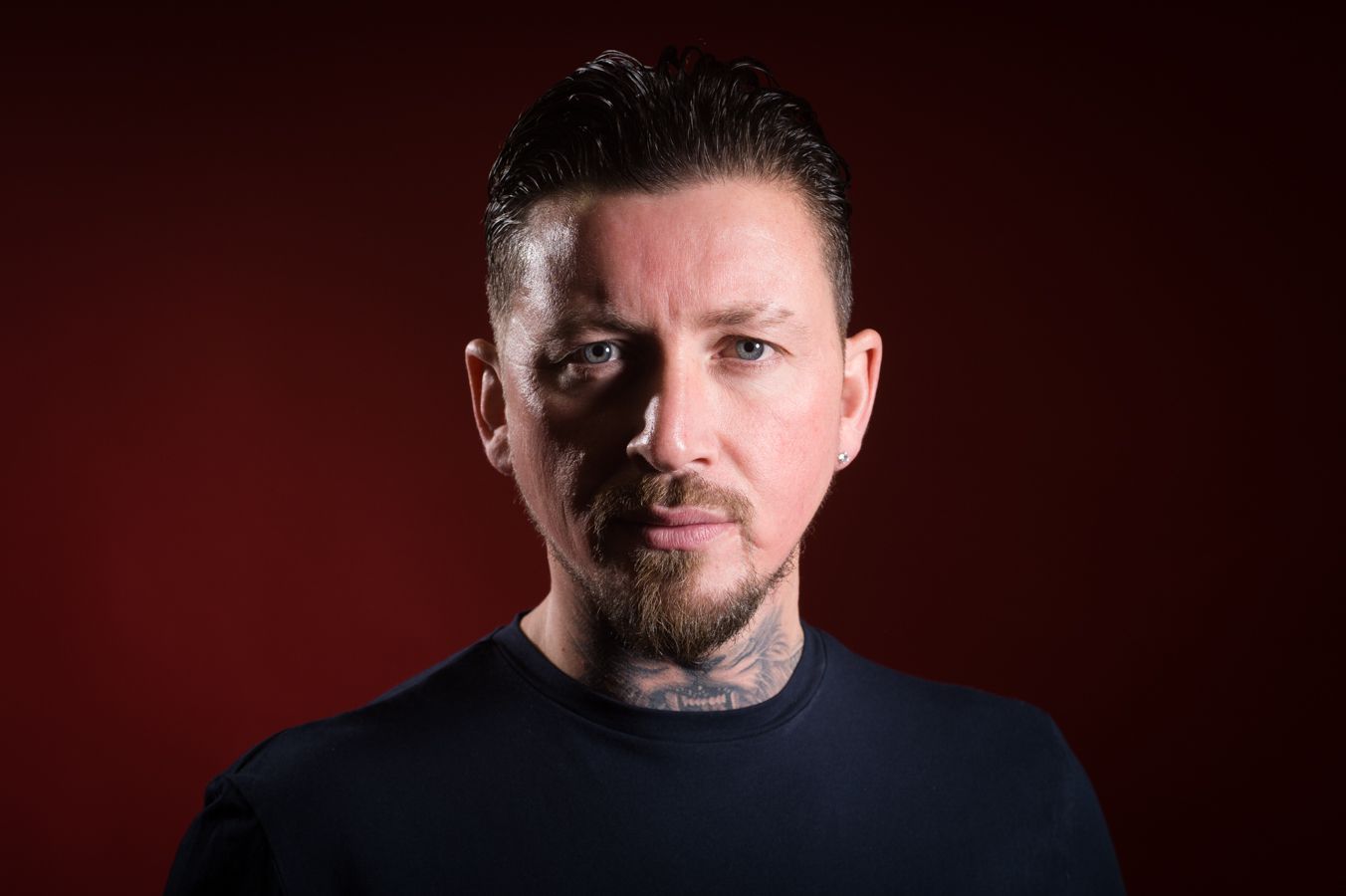 Shane McCormick, a tattooed man in a black shirt, photographed for role as actor and movie producer at Abigail's Studio in Buckinghamshire.