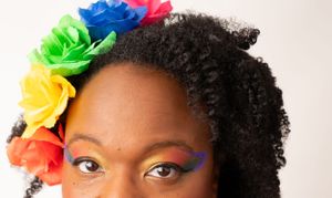 Rainbow flower crown and colorful eye makeup detail shot.