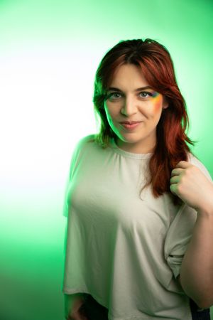 A portrait photoshoot series with green lighting featuring playful poses.