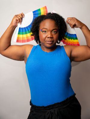 Series of shots with person holding rainbow fan while wearing bright blue top.