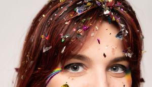 Close-up profile view with glittering confetti creating magical effect.