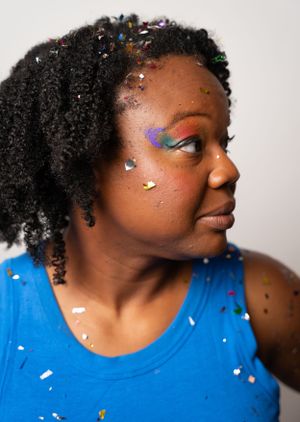 Close-up side profile shots showing colorful glitter makeup and natural curly hair.