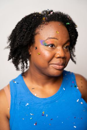 Artistic portrait series featuring bright makeup and natural hair with scattered glitter details.