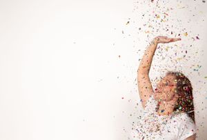 Artistic floor poses with scattered confetti showing movement and expression.
