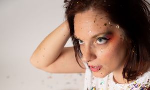 Artistic portrait series with glitter makeup and rainbow accents.