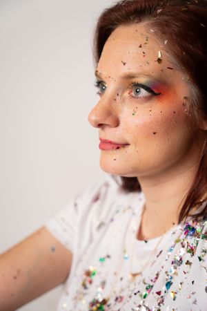 Beauty portraits showcasing colorful makeup and scattered glitter effects.
