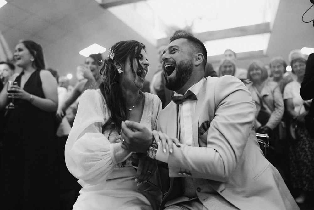 Wedding guests dance and celebrate together during a joyous reception party on the dance floor.