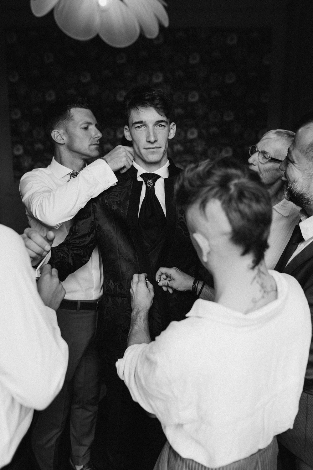 Black and white photo of dancers at a social dance event wearing formal attire from what appears to be the 1950s.