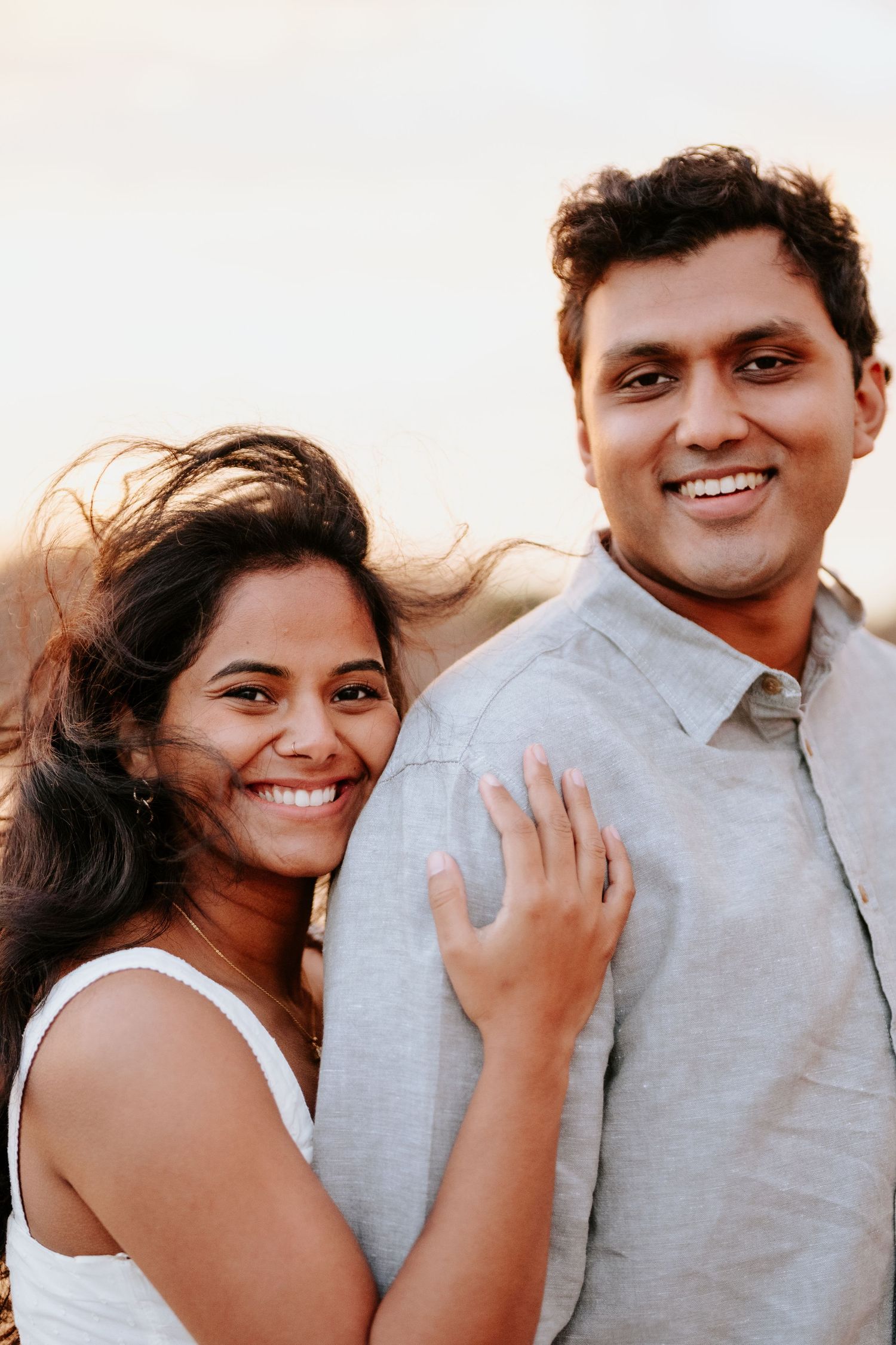 A series of candid photos showing a couple embracing and laughing together during a casual outdoor photoshoot.