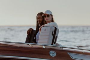 Two people relaxing together on wooden boat deck at sunset.