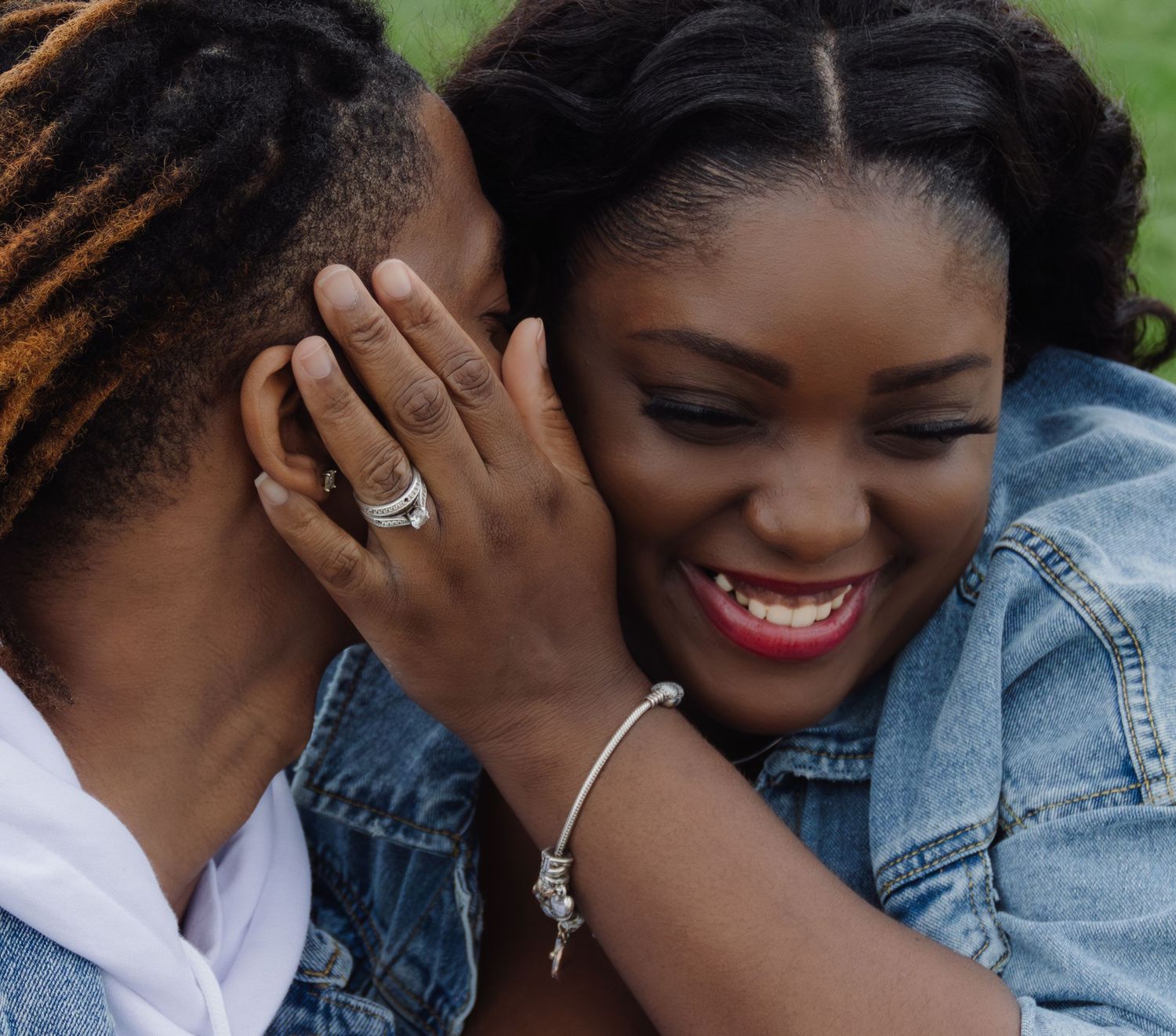 Close-up of a proposal moment showing an engagement ring and joyful expression.